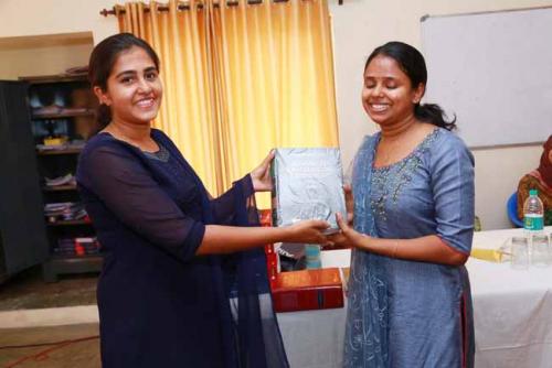 Second rank holder Priyanka Paul presents Law Lexicon (Vol III) to Ms Angel the first rank holder