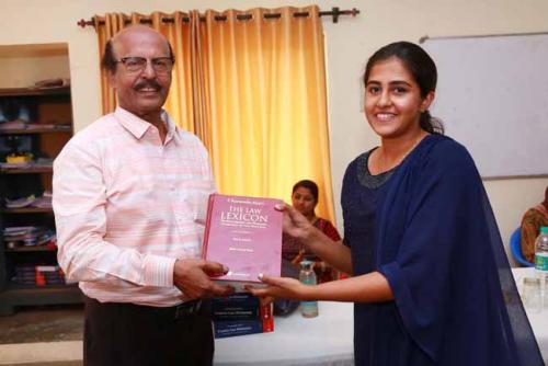  Dr CRK Nair presents Law Lexican to Priyanka Paul, Second Rank holder