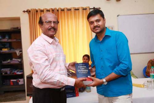  Dr CRK Nair presents Law Dictionary to the Fifth rank holder, M.Mahesh