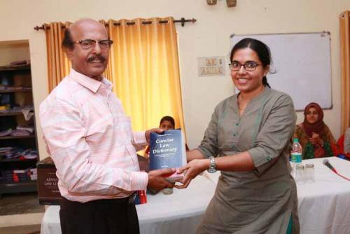 Dr CRK Nair presents Law Dictionary to the Seventh rank holder, Haritha G H
