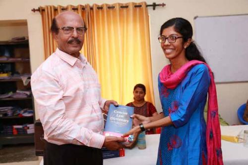  Dr CRK Nair presents Law Dictionary to the twelfth rank holder, Annu Mary Jose