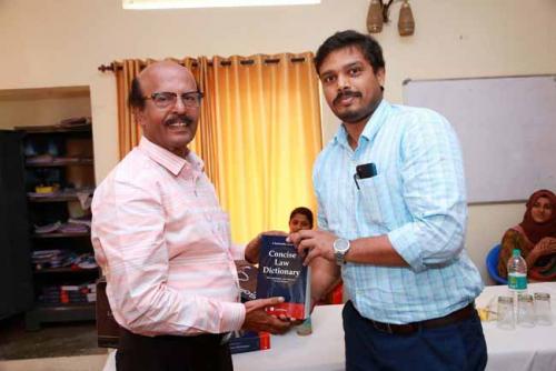 Dr CRK Nair presents Law Dictionary to the Fifteenth rank holder, Muhammed Ali