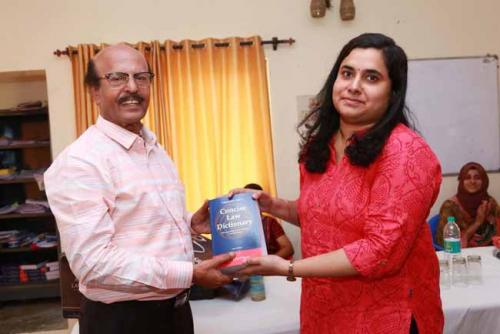  Dr CRK Nair presents Law Dictionary to the Sixteenth rank holder, Sreelekshmi C