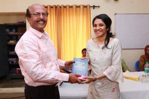  Dr CRK Nair presents Law Dictionary to the Eighteenth rank holder, Savithri