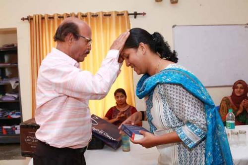  Dr CRK Nair presents Law Dictionary to the Twenty second rank holder, Reshma A
