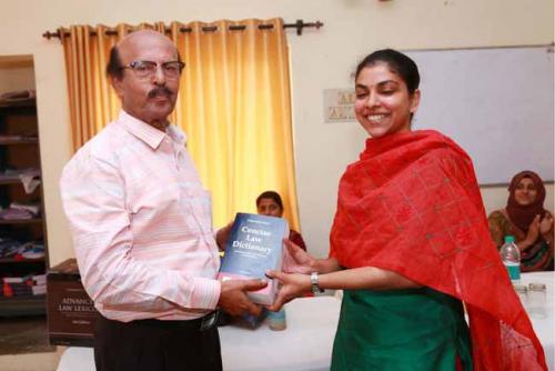 Dr CRK Nair presents Law Dictionary to the Twenty Fourth rank holder, Niyatha Prasad